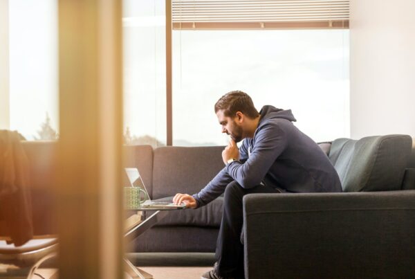 Junger Mann sucht Guthaben aus der Pensionskasse am Laptop
